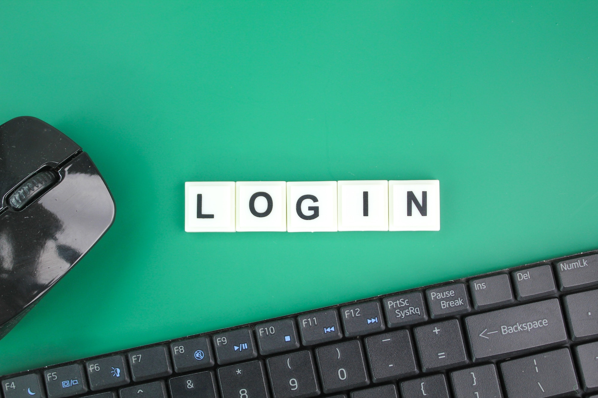 mouse and laptop keyboard with the word login.